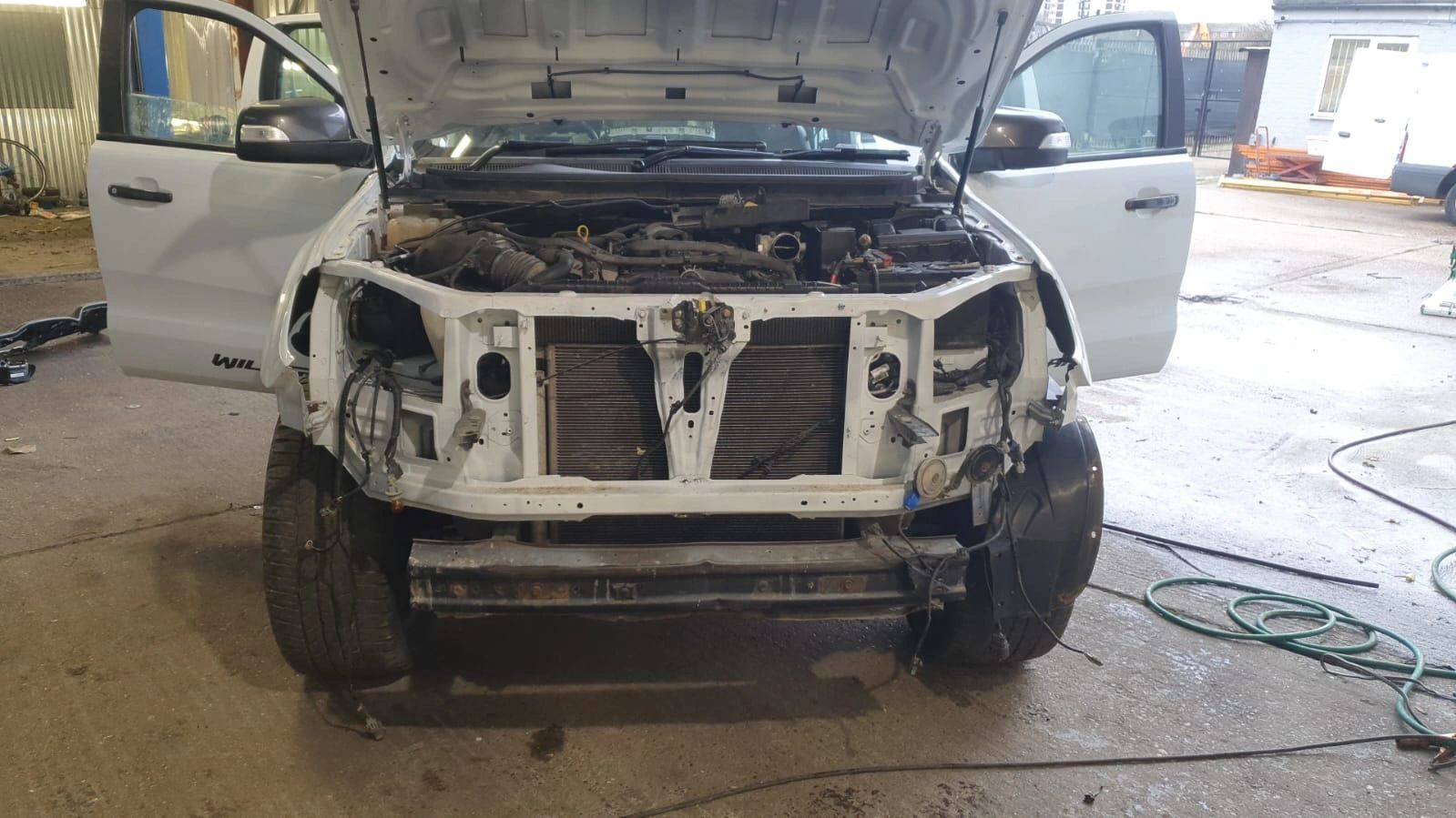 Vehicle with the front stripped and engine bay exposed for fault finding