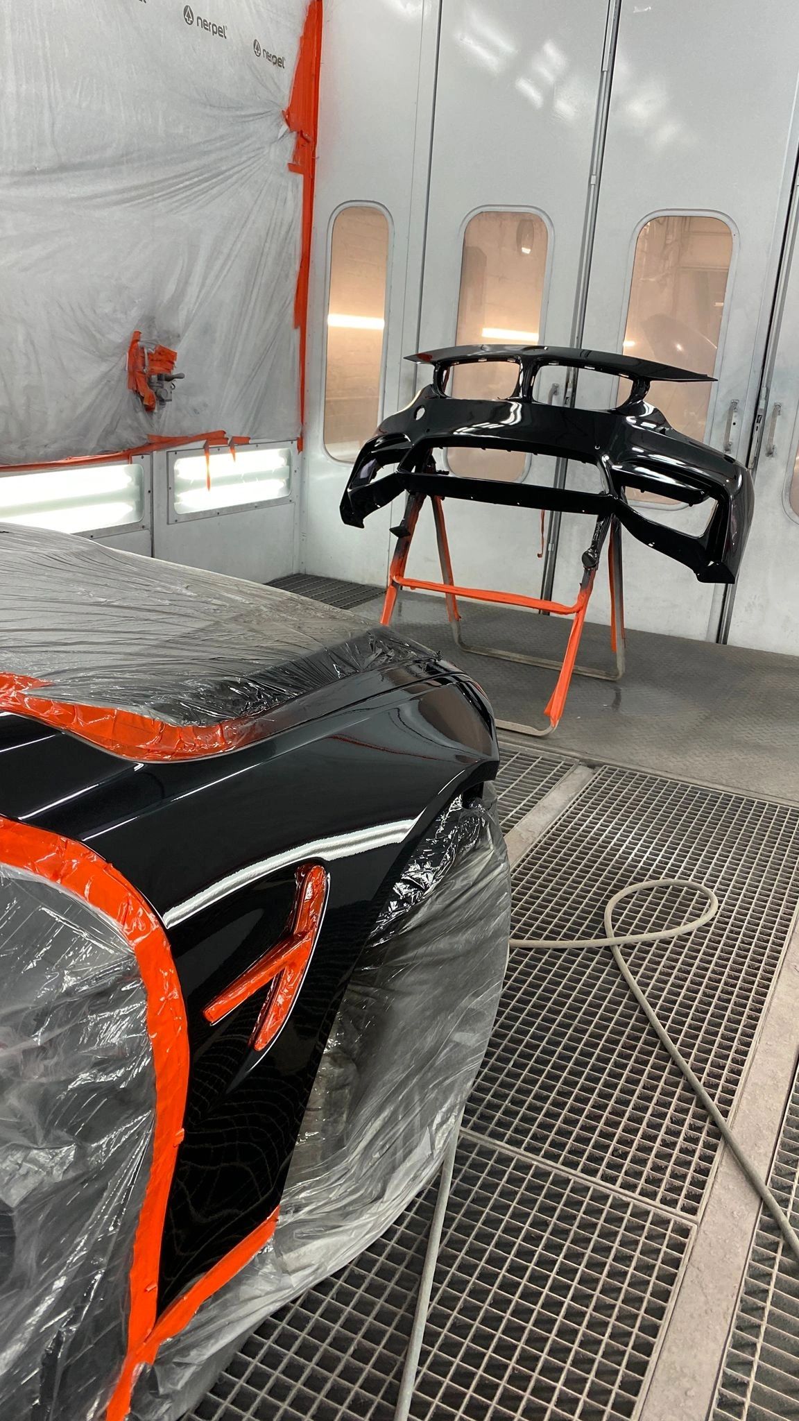 Black and orange car parts in the booth