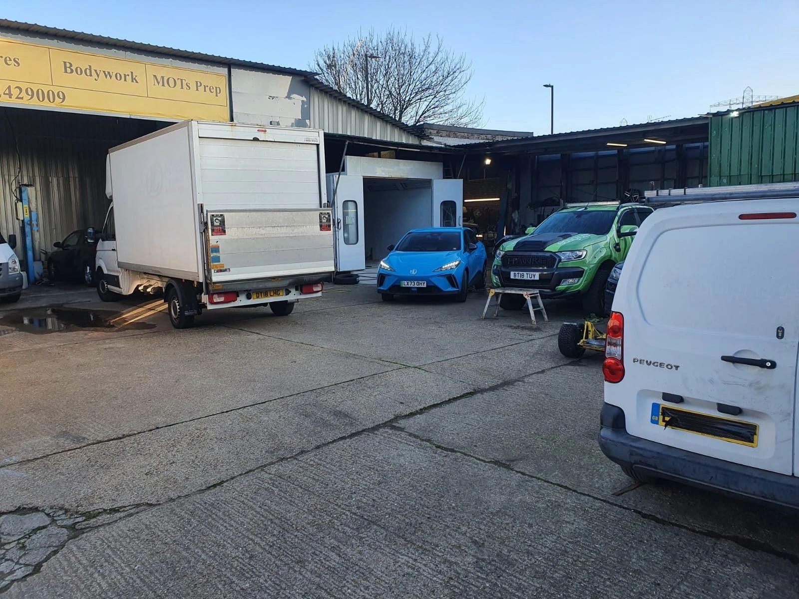 The Same Day Car Paint yard with vehicles in for repair